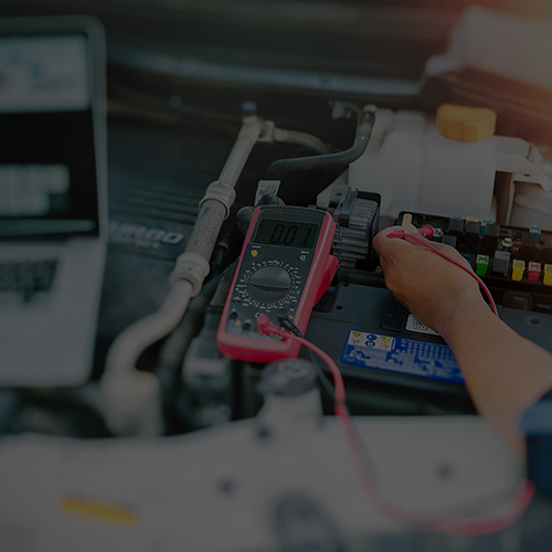 Close up of auto mechanic jumping battery